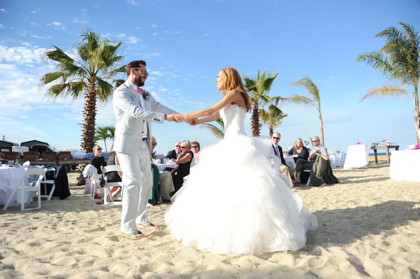 Wedding couple dancing on a beach at Ocean Place Resort & Spa