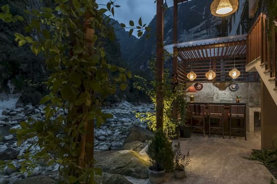 outdoor terrace next to river in aguas calientes peru
