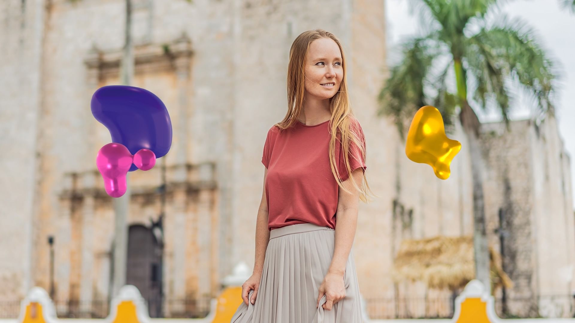 Woman in a red shirt and gray skirt smiles while standing in front of Quinta Real Oaxaca