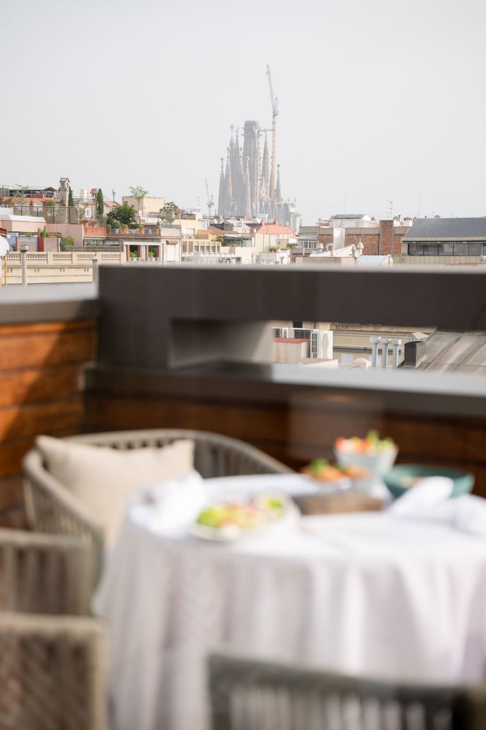 Rooftop dining setup overlooking partially constructed Sagrada Familia in the background at Almanac Barcelona