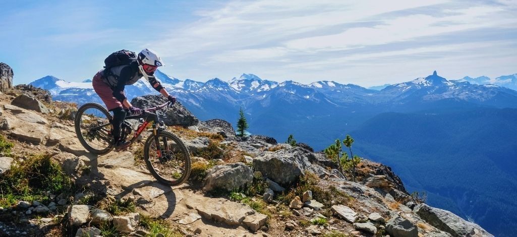 Mountain biker riding a rocky alpine trail in Whistler
