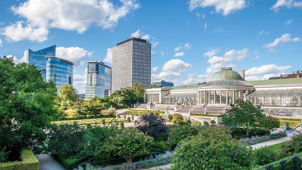 Aerial view of Brussels city with modern buildings and lush gardens.