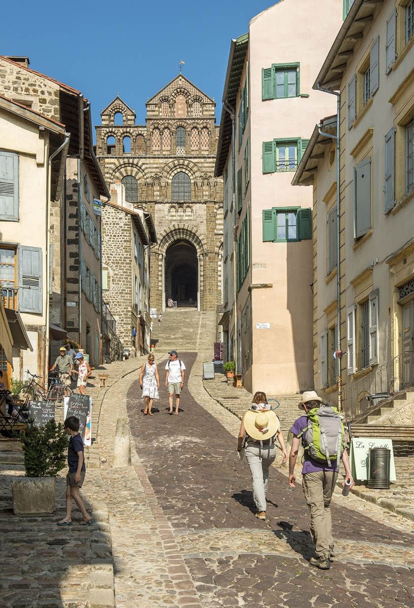 People walking on stone streets with many buildings in Bristol