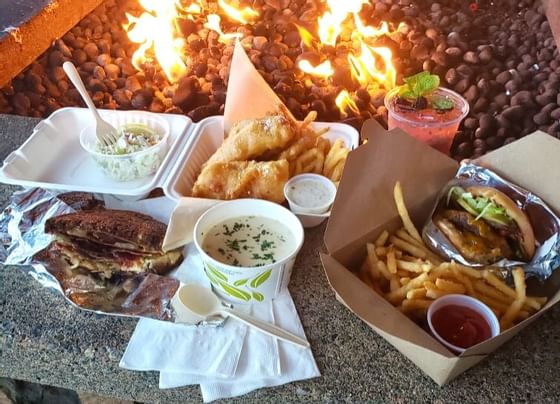 Variety of takeaway dishes served by the firepit in the Resort
