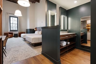 Two Queen Room with twin beds and an open bathroom vanity area at The Delegate Hotel