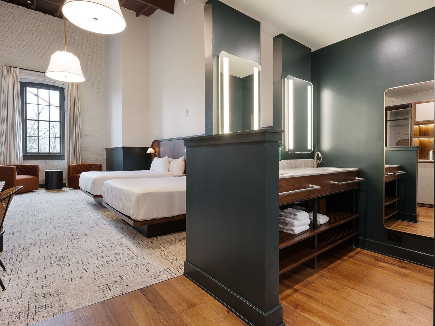 Two Queen Room with twin beds and an open bathroom vanity area at The Delegate Hotel.