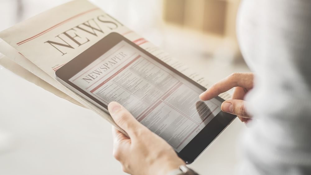 Close-up of a newspaper and tablet at Stein Eriksen Lodg