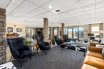 Lobby lounge area with cozy sofa & fireplace at Boothill Inn & Suites