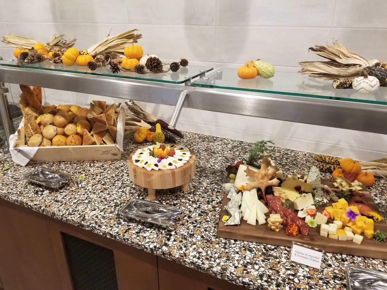 Buffet station featuring a charcuterie board, bread basket, and harvest fall decorations at The Grove Resort & Water Park