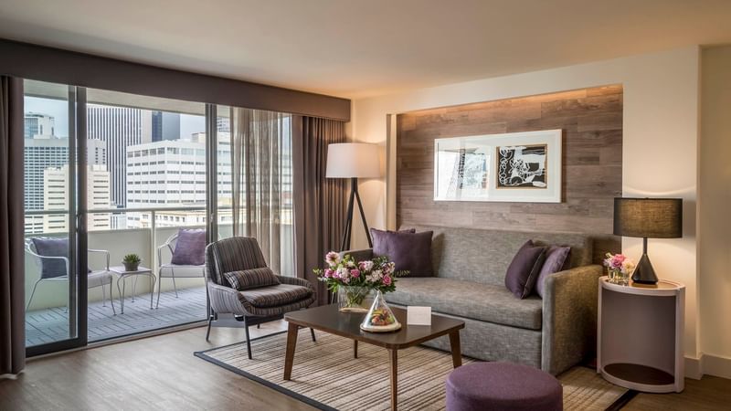 Living area and balcony view in Premiere Suite at Warwick Denver