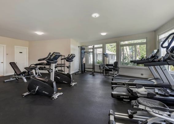 Gym equipment in the illuminated fitness center at Sebasco Harbor Resort