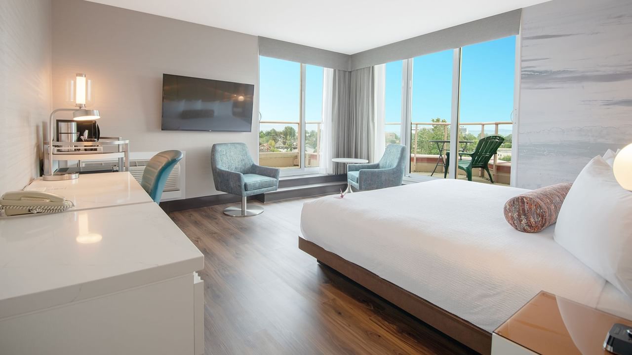 Hotel guestroom with a work desk and king bed