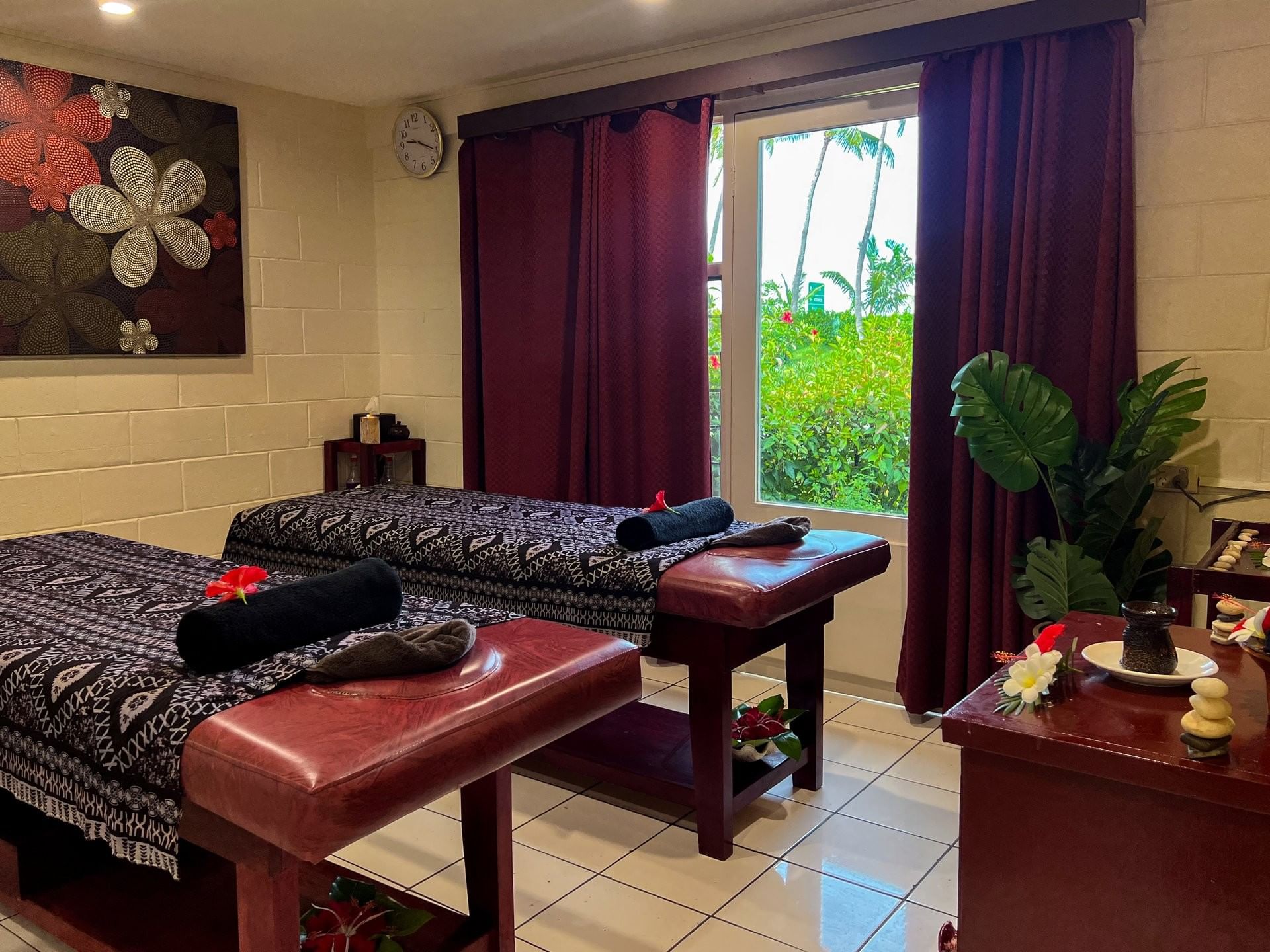 Couple's massage room featuring dark wooden tables with traditional patterned linens at TokaToka Resort Nadi Fiji
