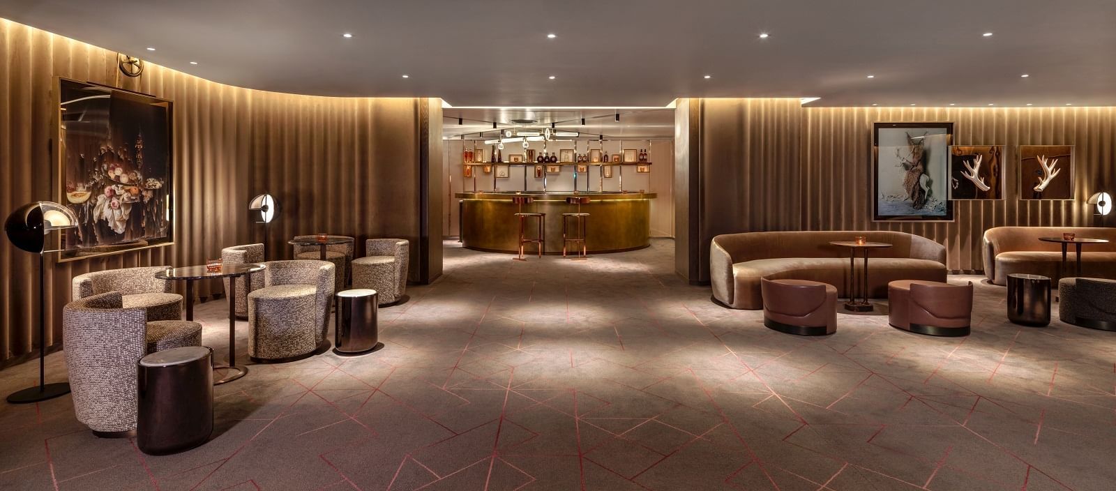 Ballroom waiting area at The Londoner Hotel with a stylish bar and spacious, varied seating options