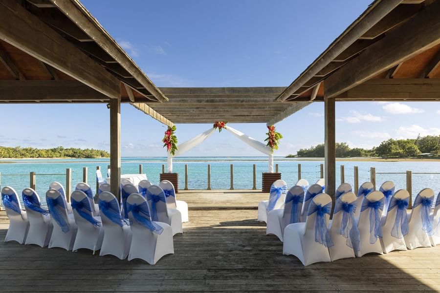 Outdoor wedding ceremony venue with blue-ribboned chairs facing the tropical ocean at warwick le lagon-vanuatu
