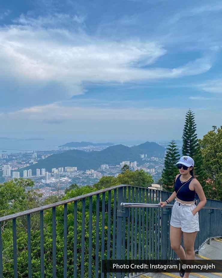 A lady was taking a picture on the stairs at Penang Hill - Lexis Suites Penang