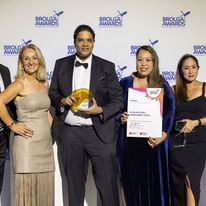 Peoples pose with Star Deluxe Accommodation Award in their hands at H on Mitchell