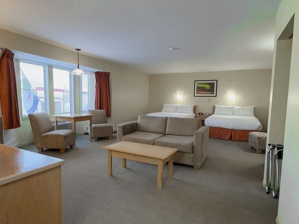 hotel room sitting area with sofa bed and coffee table