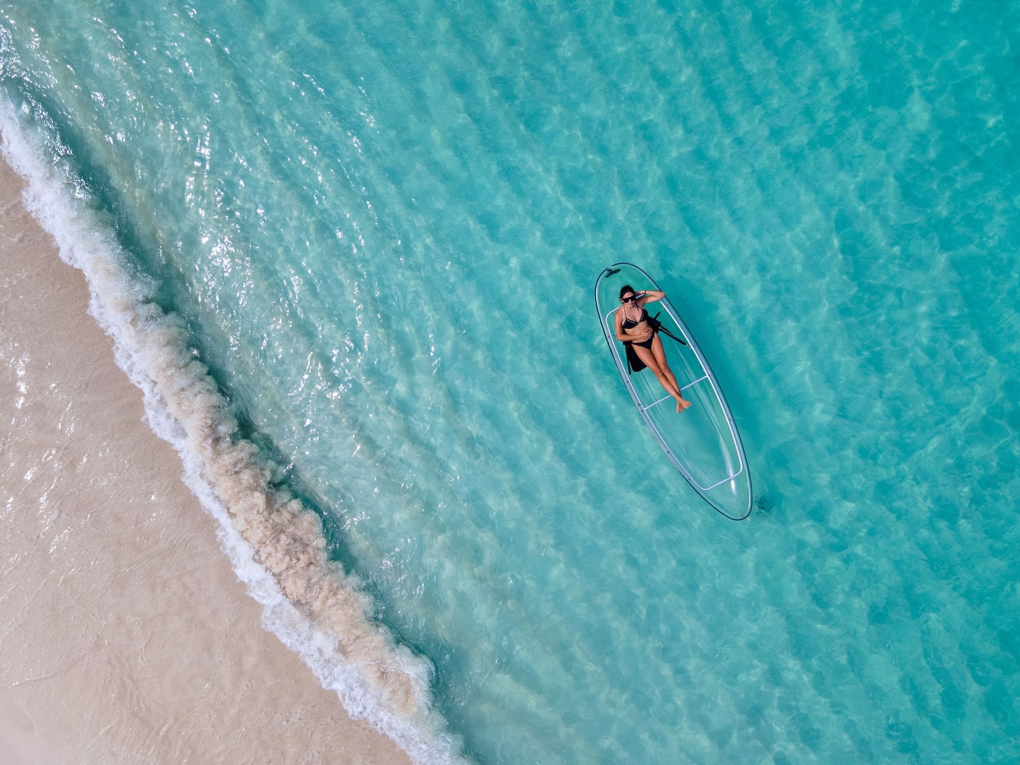 Woman on a transparent kayak at The Somerset on Grace Bay