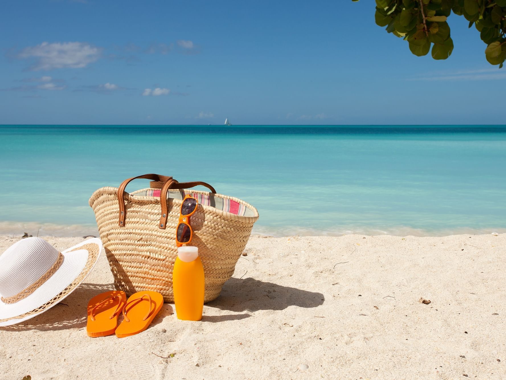 Close up of a beach bag & hat by sea at Daydream Island Resort
