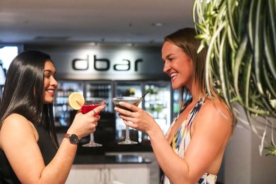 Two girls enjoying themselves in the Dbar at H On Smith Hotel