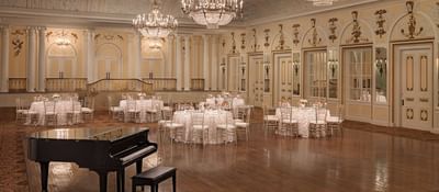 The arranged Ballroom Hall with a piano at Peabody Hotels