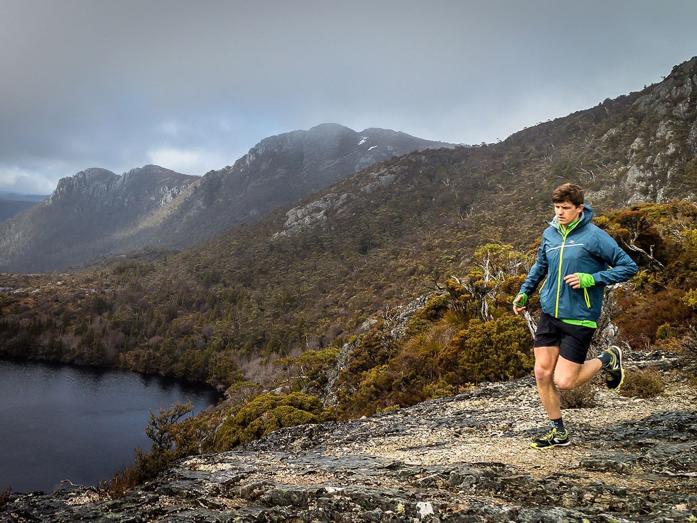 Man jogging by a cliff near Cradle Mountain Hotel  