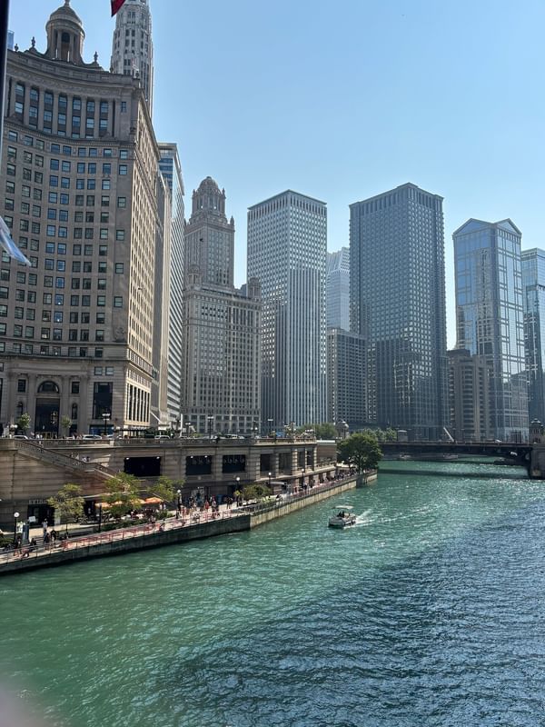 Chicago skyline with a boat cruising on the river near Warwick Allerton Chicago