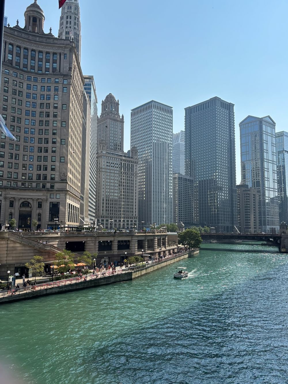 Chicago skyline with a boat cruising on the river at Warwick Allerton Chicago Redesign