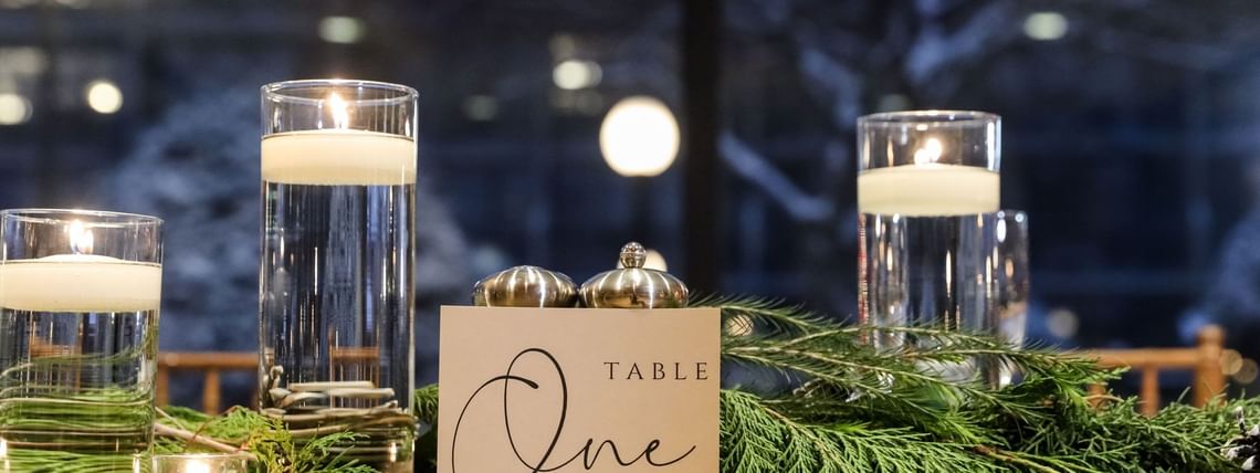 Table setting with candles and greenery at Mingle All the Way in High Peaks Resort, Lake Placid.
