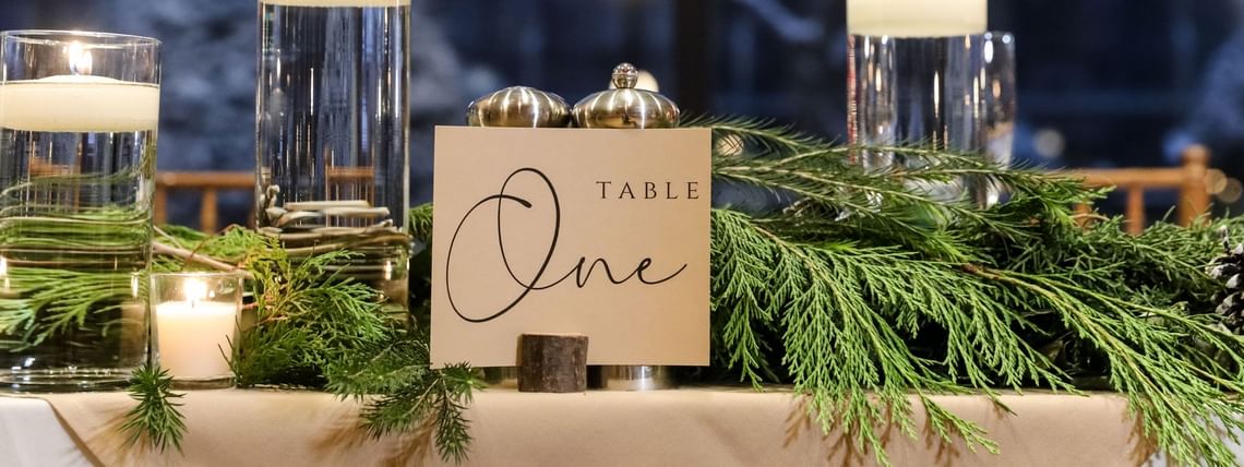 A table adorned with candles and greenery at High Peaks Resort