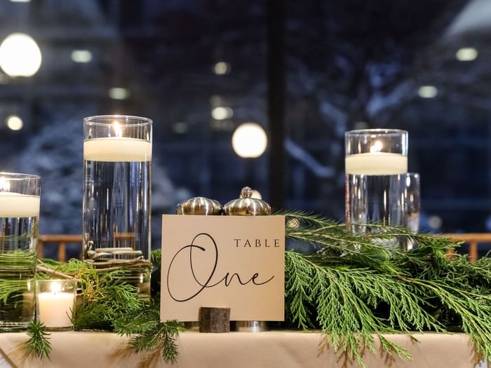 A table adorned with candles and greenery at High Peaks Resort