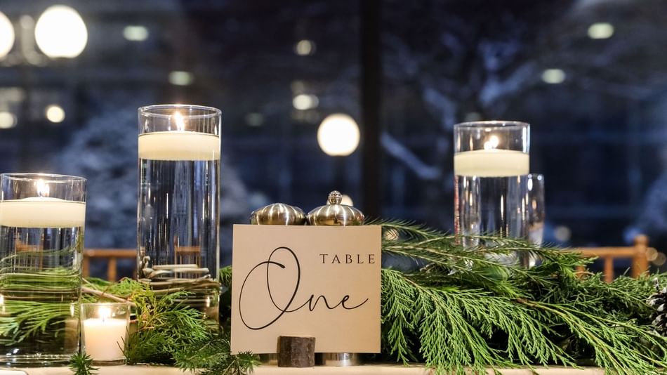 A table adorned with candles and greenery at High Peaks Resort