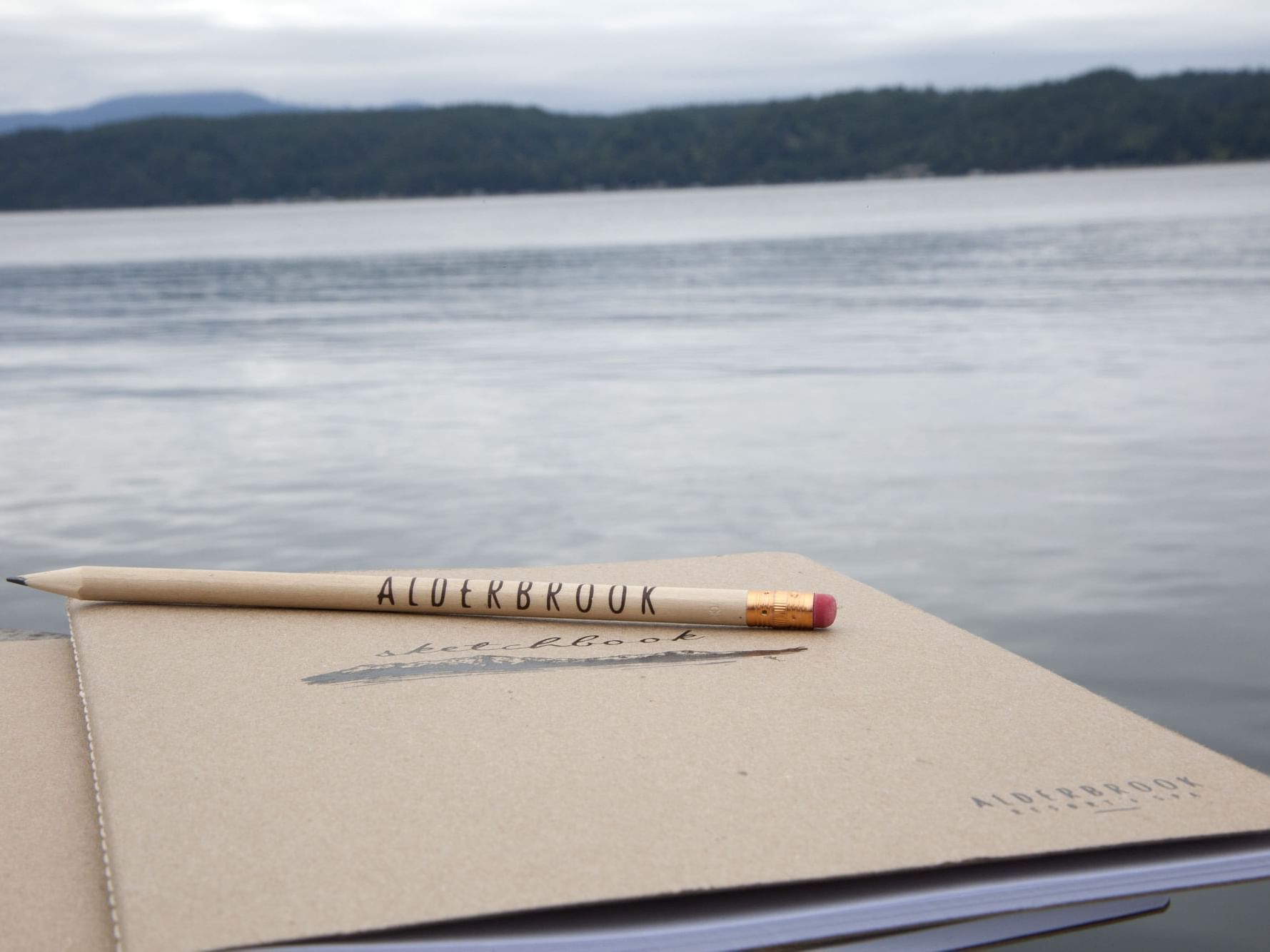 Notebook and a pencil featuring the hotel name by the Lake at Alderbrook Resort & Spa