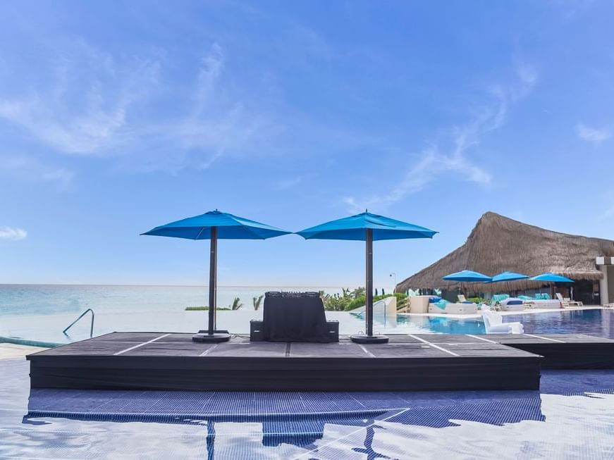 Pool bed with pool umbrella near the beach at Live Aqua Resorts