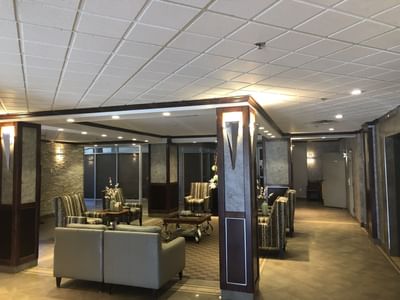 The elegant lobby features comfortable couches and chairs at Nomad Hotel