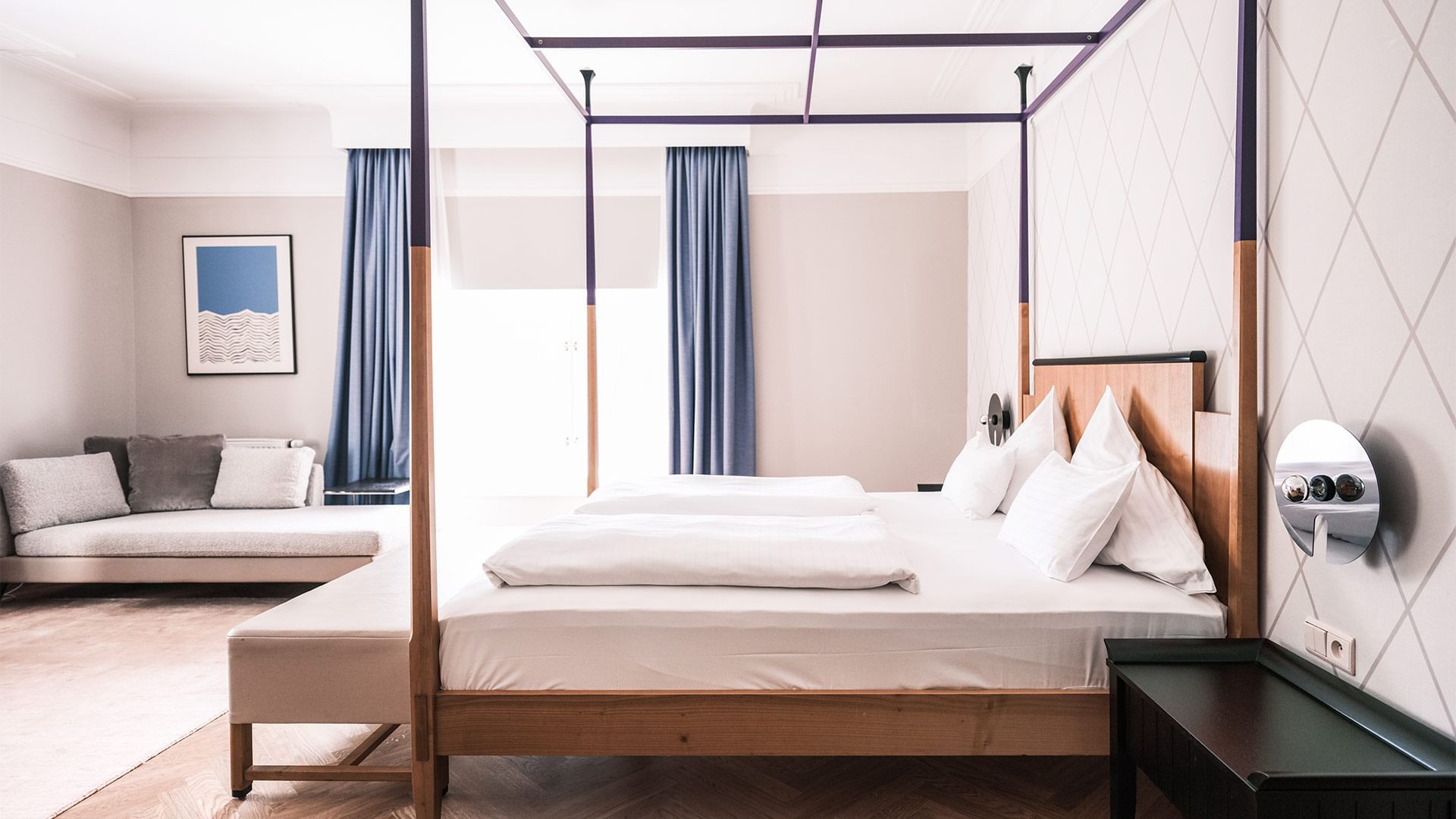 Large bed & lounge in Junior Suite at Falkensteiner Hotels