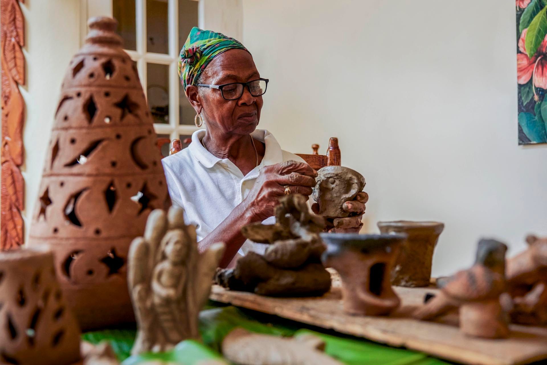 A woman shaping clay pots, things to do in St Lucia at Ladera Resort