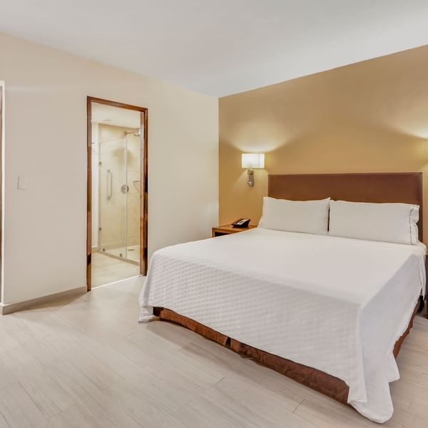 Comfy king bed in Junior Suite at Fiesta Inn Hotels