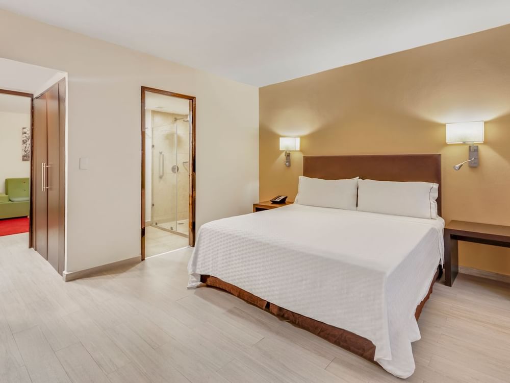 Comfy king bed in Junior Suite at Fiesta Inn Hotels