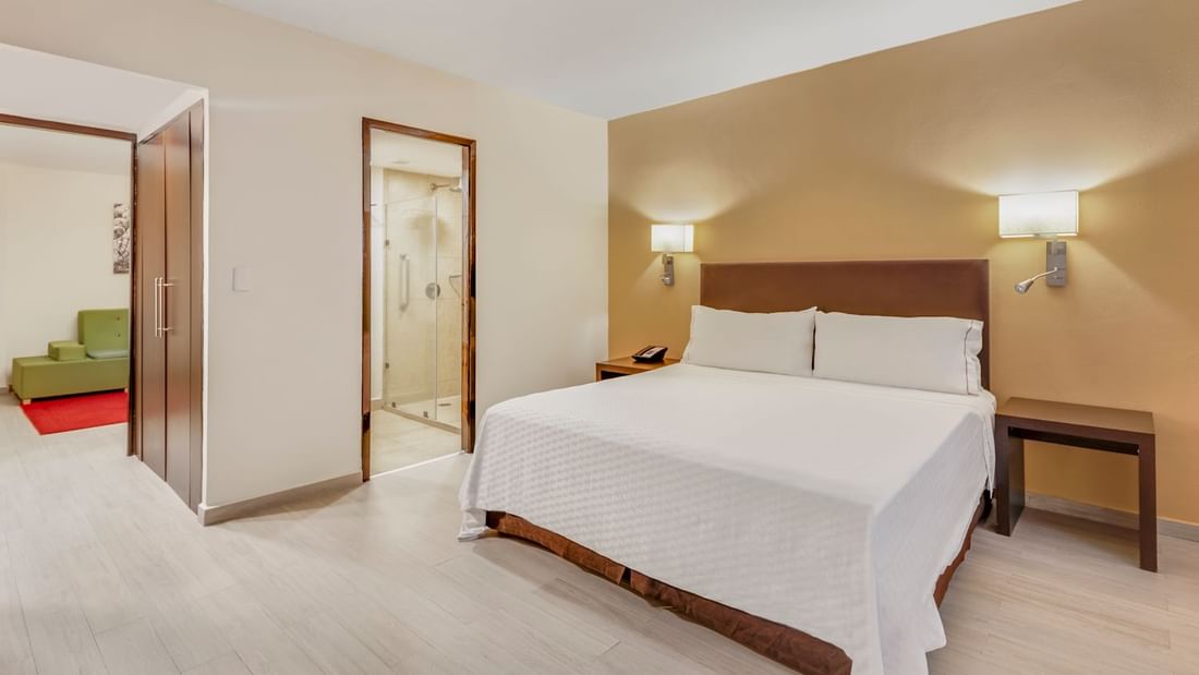 Comfy king bed in Junior Suite at Fiesta Inn Hotels