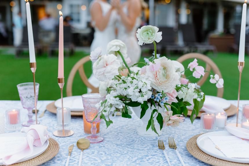 Close-up of a floral wedding table decor set outdoors at Ogunquit Collection