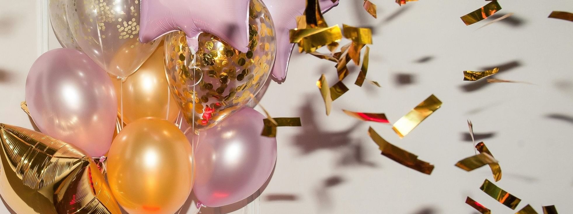 Golden and pink balloons with falling confetti at Novotel Sydney International Airport