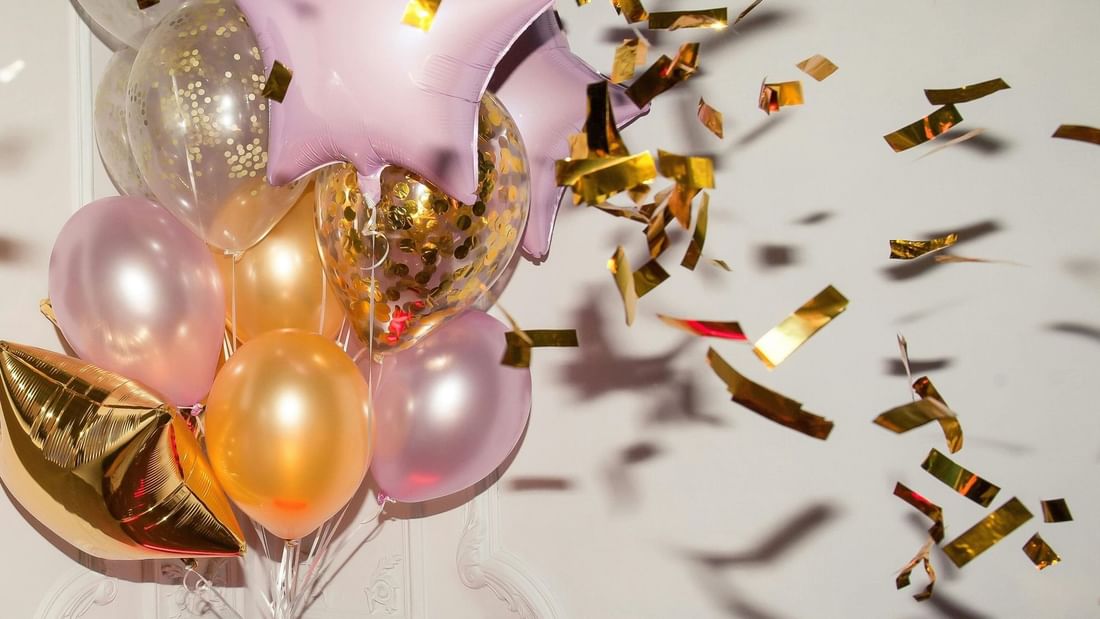 Golden and pink balloons with falling confetti at Novotel Sydney International Airport