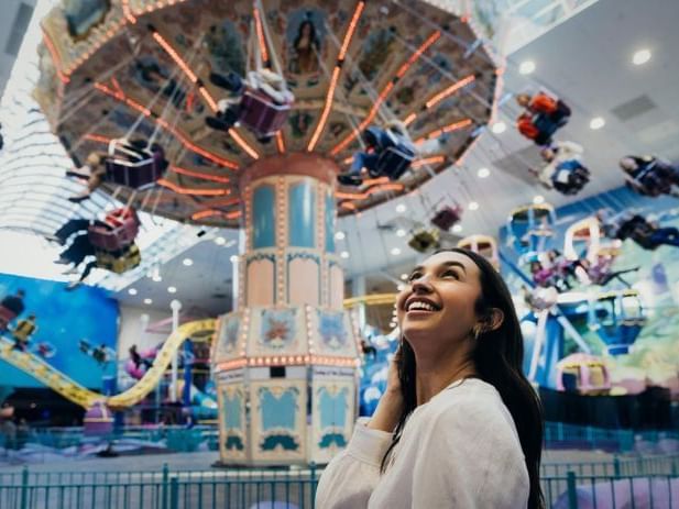 Woman overlooking amusement park ride at World Waterpark