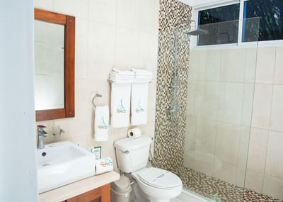 Bath towels & shower cubical with amenities in Double Twin Room at Cha Cha Hotel