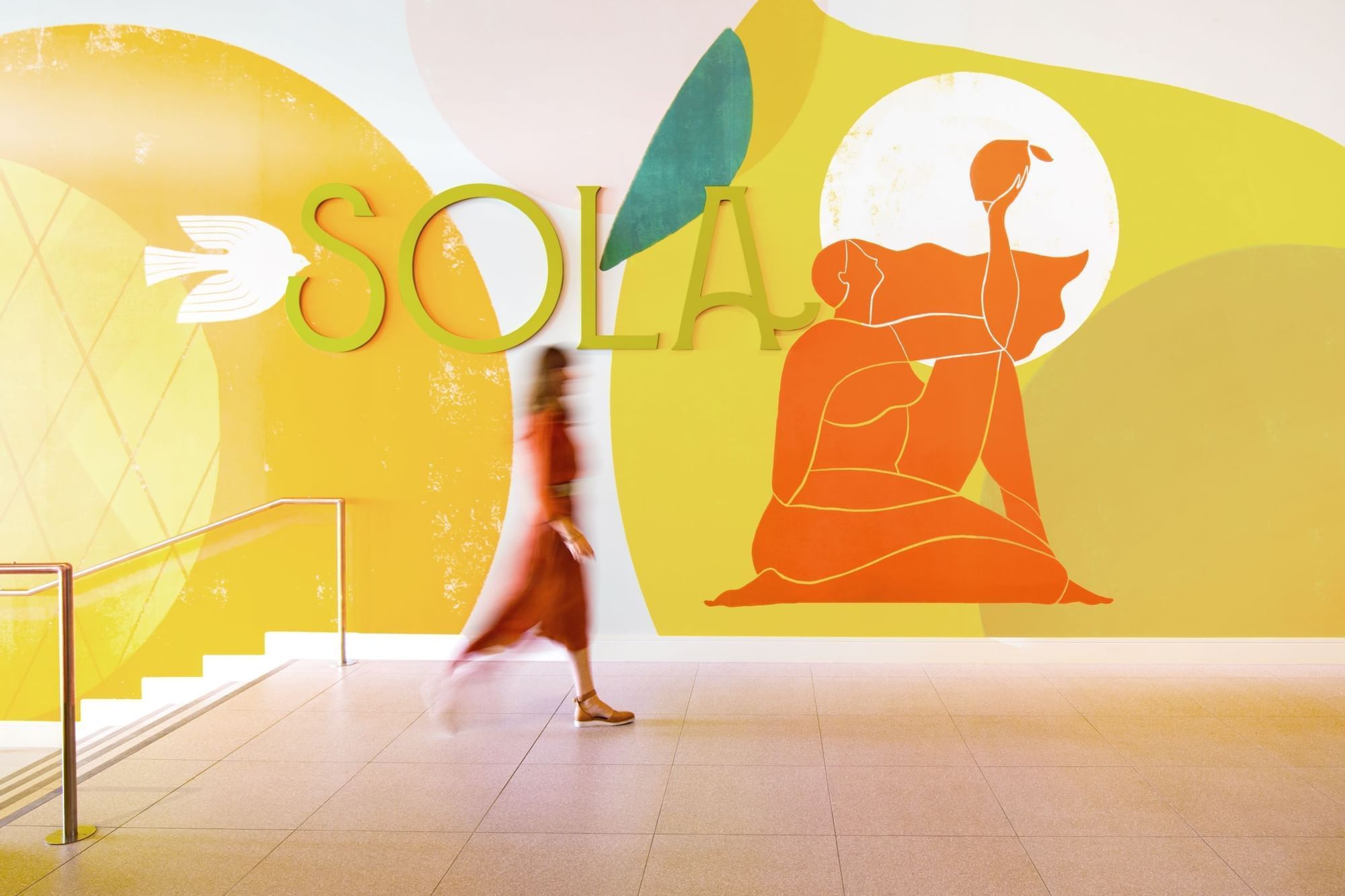A lady passing SOLA in Novotel Sunshine Coast Resort