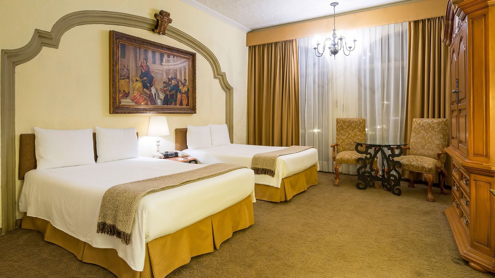 2 Double Master Suite with two queen beds and a large arched mural at Quinta Real Aguascalientes