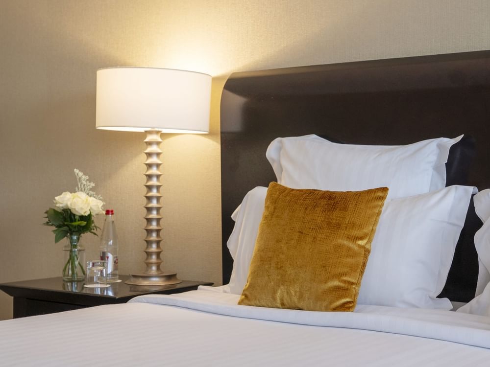 Une chambre Junior Suite à la décoration élégante et dotée d'un lit douillet au Warwick Champs-Élysées Paris.