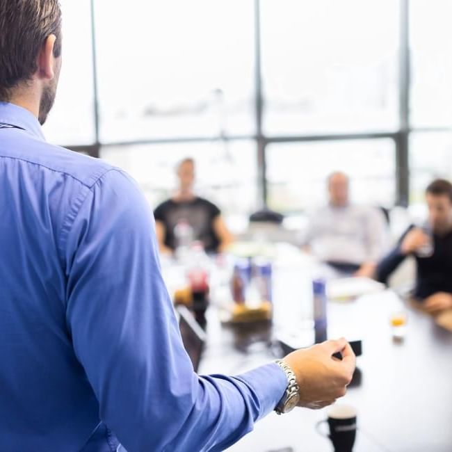 Man delivering a successful presentation featuring our article on 